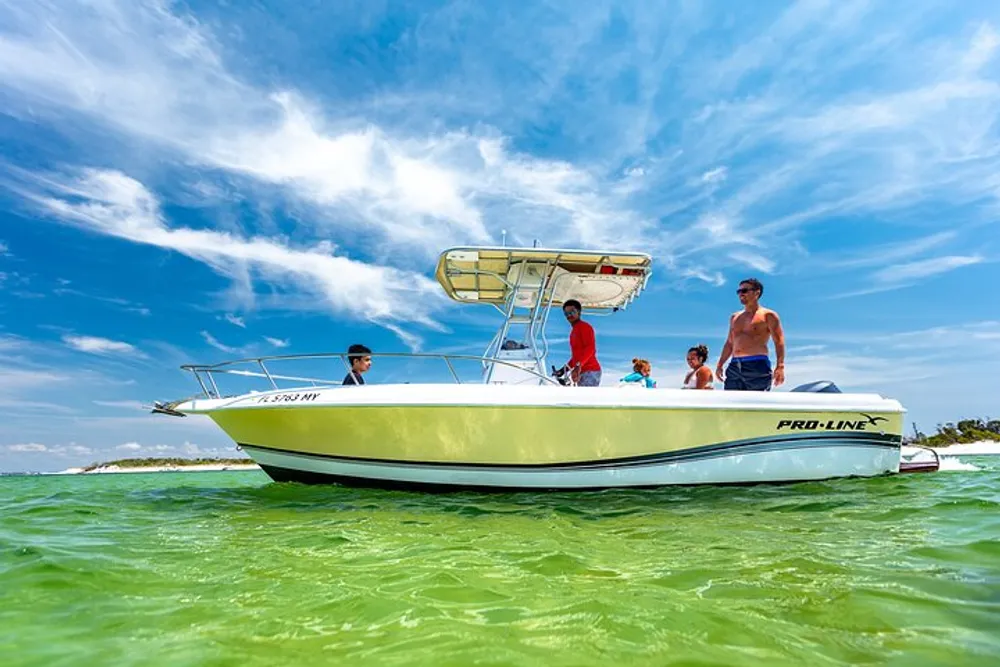 A group of people are enjoying a sunny day on a white and green Pro-Line motorboat anchored in clear shallow waters
