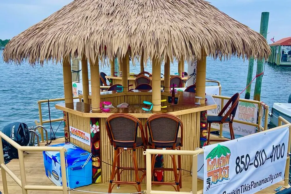 The image displays a floating tiki bar with a thatched roof bar stools and tropical decorations docked at a waterfront
