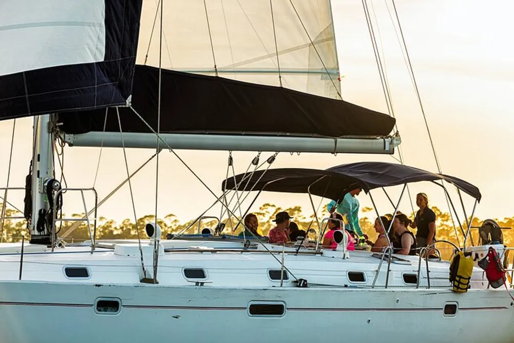 A group of people are enjoying a sailing trip on a yacht during a sunny day