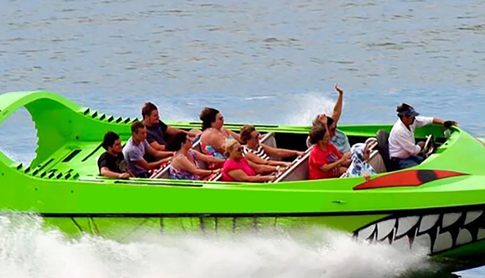 A group of people are riding in a high-speed boat designed to look like a crocodile creating a spray of water as they move