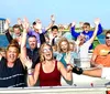 A group of people are experiencing a high-speed thrill ride on a boat designed to look like a menacing green creature with sharp teeth spraying water behind as it races forward