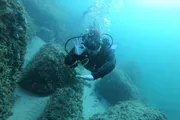 A scuba diver gives an 