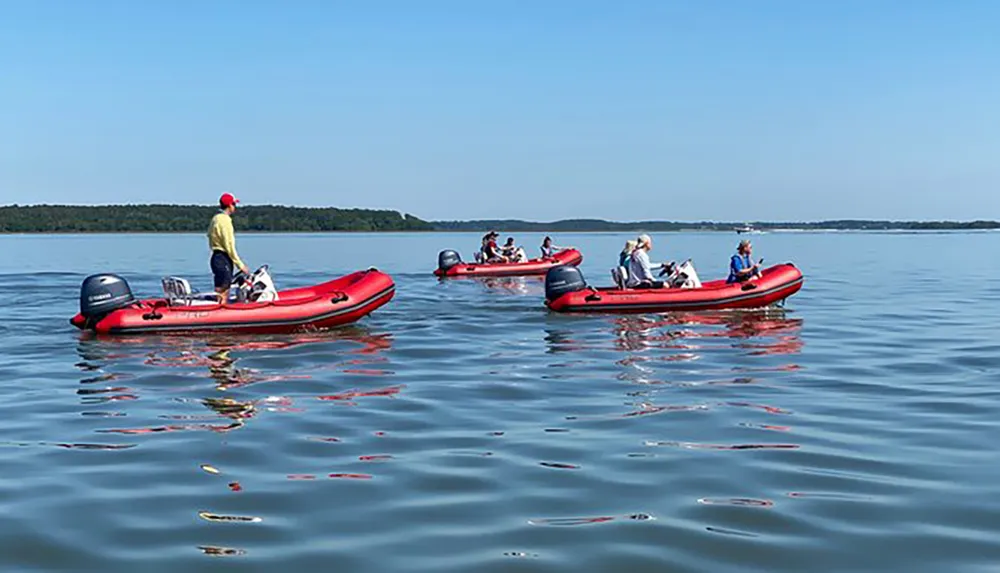 Several people are enjoying a sunny day on the water with their inflatable boats