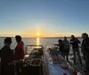 Two chefs are grilling an assortment of fresh vegetables and meats on a boat