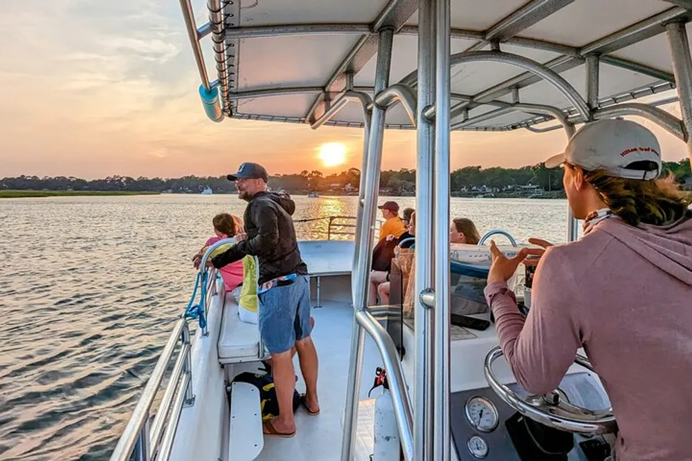 Passengers enjoy a scenic boat ride at sunset