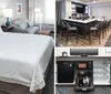 The image displays a neatly arranged hotel room with a large bed a sitting area and a workspace with a TV