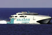 A white and blue high-speed ferry labeled 