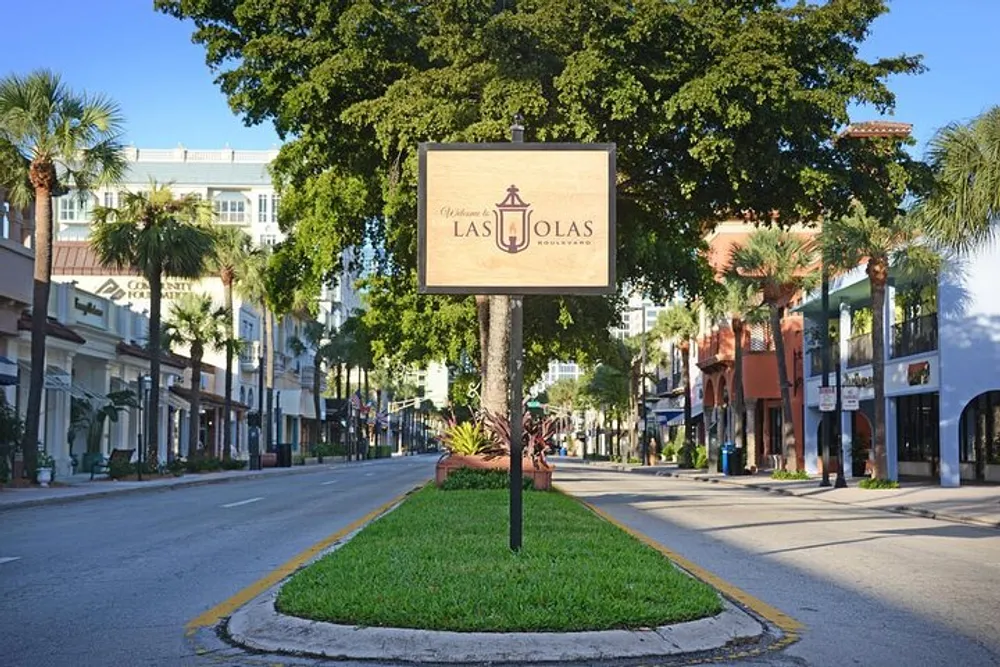 The image shows a sunny street view with a sign reading Las Olas palm trees and stores along a quiet boulevard
