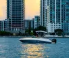 The image captures a motorboat cruising on the water near an urban skyline during sunset with the suns reflection on the water