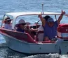Passengers are enjoying a ride in a red and white speedboat cruising through water