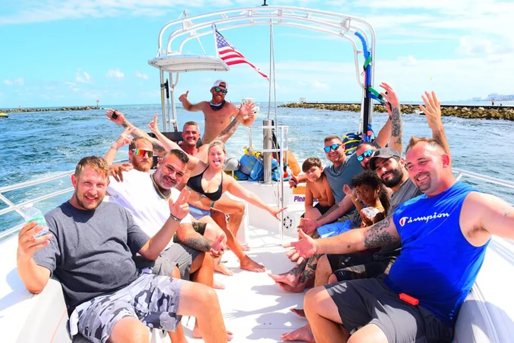A group of cheerful people is enjoying a sunny day on a boat waving and smiling at the camera
