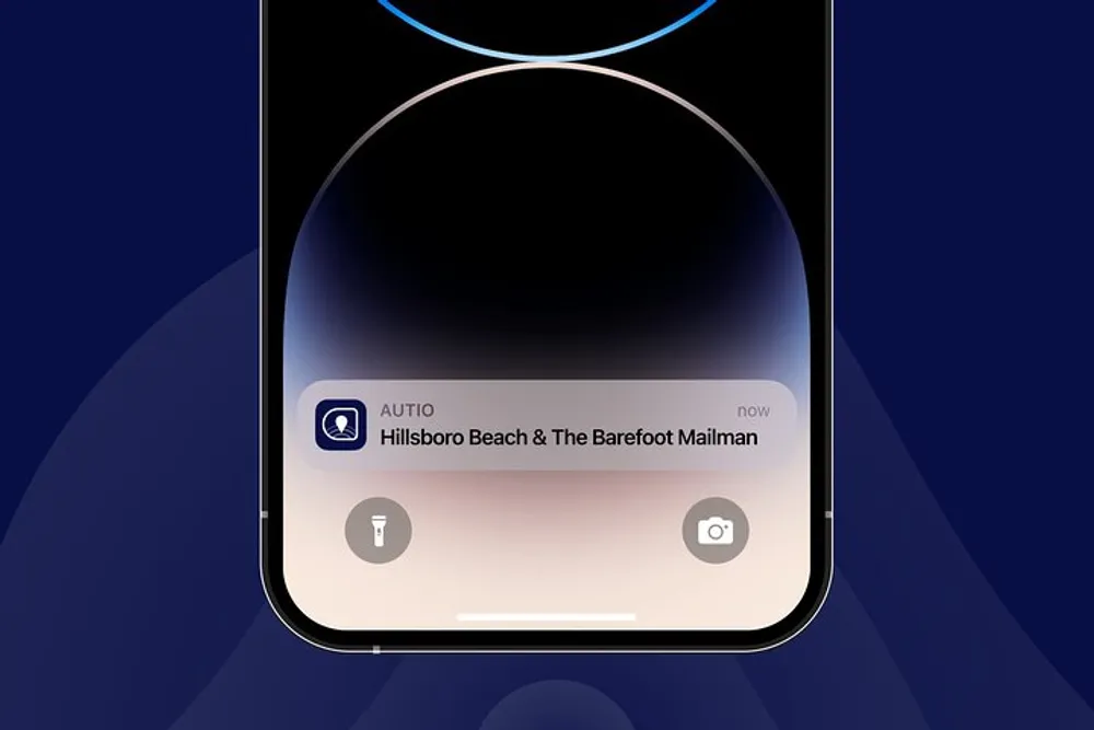 The image shows a smartphone screen with a notification from an app called AUTIO displaying a message about Hillsboro Beach  The Barefoot Mailman