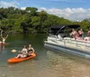 A group of people is enjoying a sunny boat ride with some individuals posing for the camera showcasing a cheerful and leisurely experience