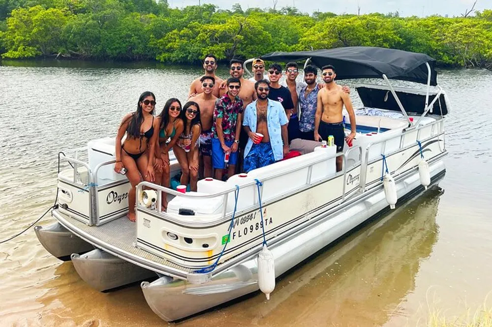 A group of friends is posing for a photo on a pontoon boat enjoying a sunny day by the water