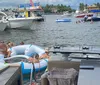 A group of women are relaxing and enjoying drinks on a large inflatable raft on the water