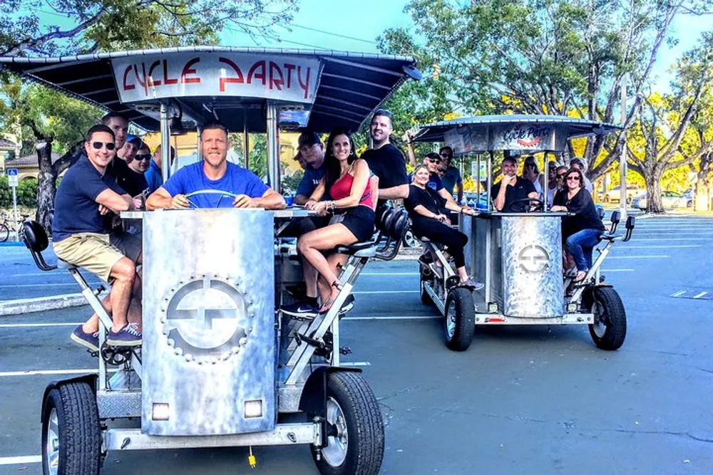 A group of people are enjoying a ride on a multi-person pedal-powered vehicle called a Cycle Party