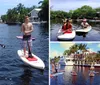 A group of cheerful people are posing on paddleboards on a calm water surface surrounded by natural scenery