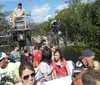 This image shows a group of tourists enjoying a ride on an airboat through a waterway surrounded by lush vegetation likely in a swamp or wetland area