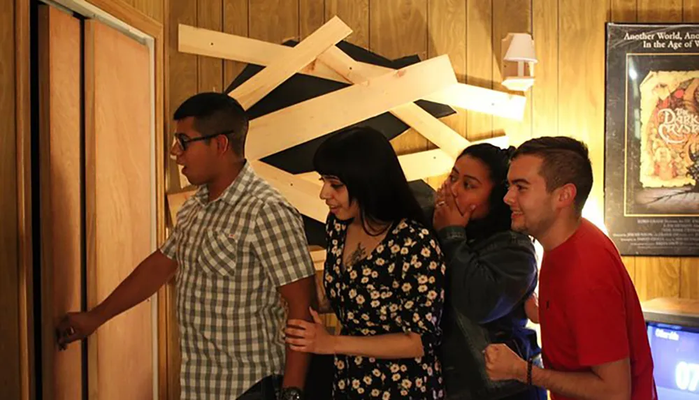 A group of individuals appears engaged and possibly intrigued or anxious as one person opens a door that is part of a barricaded wooden structure while others look on with anticipation