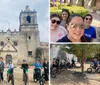 A group of people on electric bikes are posing for a photo in front of an old church with two bell towers