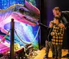 An adult and two children are looking at a brightly illuminated dinosaur exhibit