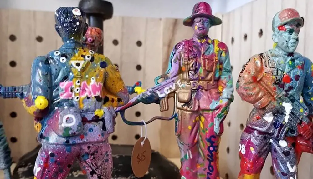 The image shows three colorful paint-splattered figurines resembling soldiers each with a distinctive pose and style marked with price tags