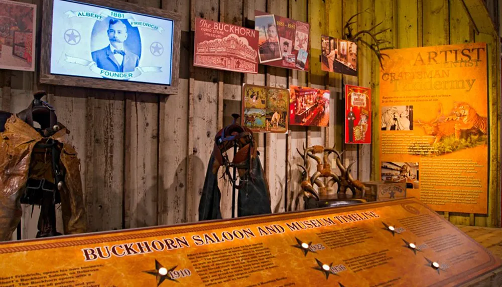 The image depicts an interior view of the Buckhorn Saloon and Museum showcasing its rustic decor historical exhibits taxidermy and a timeline of the establishments history