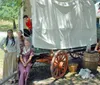 The image shows a museum exhibit featuring a tipi artifacts and informative displays about the Comanche and Kiowa peoples