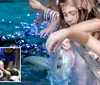 Children are seen delightfully interacting with aquatic animals touching a ray in a touch pool and meeting penguins in an inset image reflecting an educational and engaging experience at an aquarium