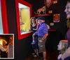 A group of people including children are looking at a display containing a bat-like creature in a brightly lit exhibit with an inset image of a man dressed as a cowboy