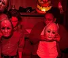 A group of people is engaging in an escape room-like setting examining tarot cards on a table with positive customer reviews and star ratings displayed