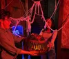 A group of people is engaging in an escape room-like setting examining tarot cards on a table with positive customer reviews and star ratings displayed