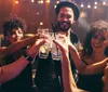 A group of friends are toasting with drinks at a vibrant party