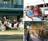 A white horse pulls a decorative carriage with passengers through a sunny urban area driven by a person wearing a hat