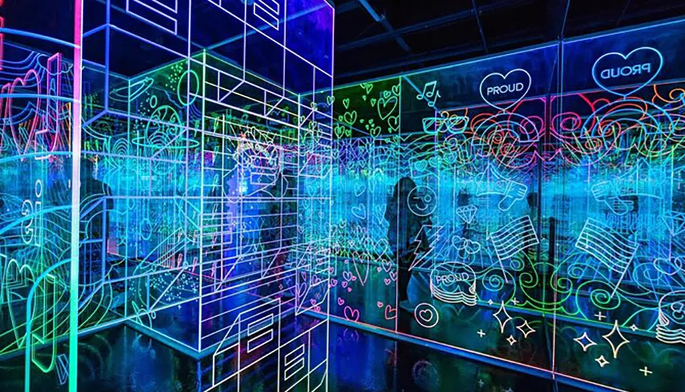 The image displays a vibrant neon-lit room with reflective floors and graffiti-style drawings that create a visually stimulating immersive experience