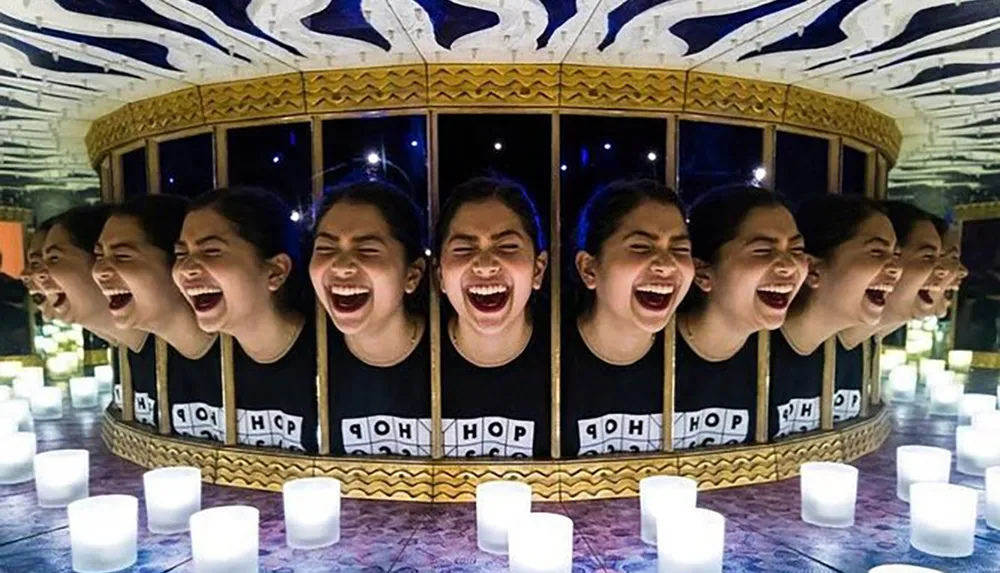 The image shows a laughing girls reflection repeated multiple times in curved mirrors creating a circular pattern of identical joyous expressions