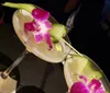 Two elegant cocktails garnished with orchids and slices of cucumber are presented on a dark surface creating a sophisticated and visually pleasing aesthetic