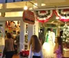 Passengers are enjoying a festive ride in a trolley adorned with twinkling lights looking out at colorful illuminations outside