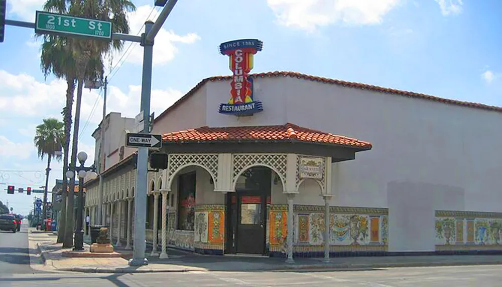 The image shows a Spanish-style building with colorful tiled walls featuring a sign that says Since 1935 above the words Cuban Restaurant