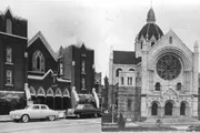 The image shows a side-by-side comparison of two different church buildings, with vintage cars parked in front of the one on the left and the right image appearing older and more historical in style.