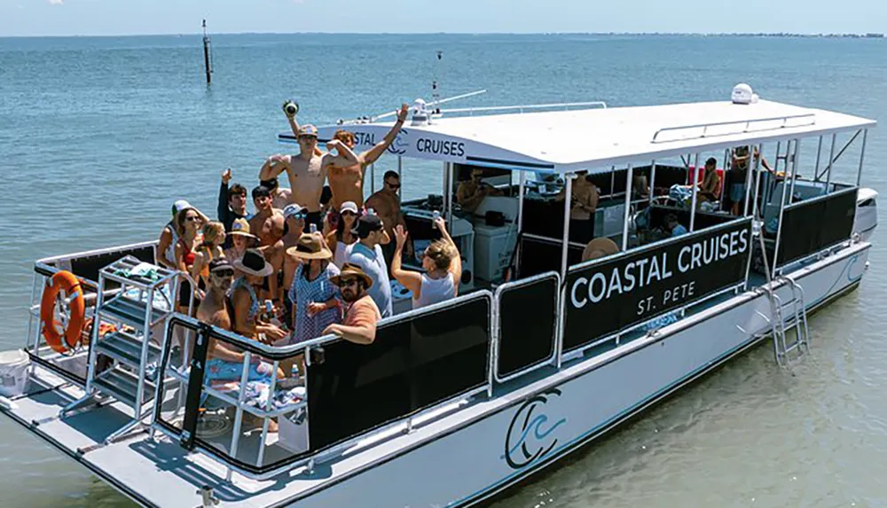 A group of people are enjoying a sunny day on a Coastal Cruises tour boat