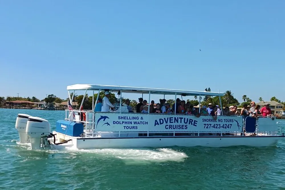 The image shows passengers on a boat with signage that advertises Shelling  Dolphin Watch Adventure Cruises suggesting a recreational tour on water