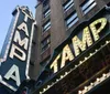 The image shows a marquee with the word TAMPA illuminated by light bulbs likely representing the signage of a theater or similar establishment