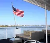 A group of passengers is enjoying the view from the decks of the StarLite Majesty dining cruise ship as it sails in a body of water