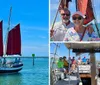 A sailboat with red sails is navigating the sea under a clear blue sky with several people visible on deck