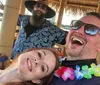 A group of people enjoys a gathering on a floating tiki bar boat at sunset
