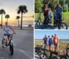 Two people are smiling and posing on their bicycles during sunset by a palm-lined waterfront