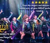 A group of lively performers are dancing on stage in colorful outfits with vibrant lighting effects in the background