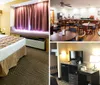 The image shows a neatly organized hotel room with a large bed topped with a patterned bedspread flanked by a desk and entertainment unit with curtains drawn near a window bench under warm lighting