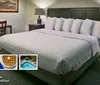 The image features a cozy hotel room with a neatly made bed alongside highlights of amenities such as free WiFi an outdoor pool and a complimentary hot breakfast